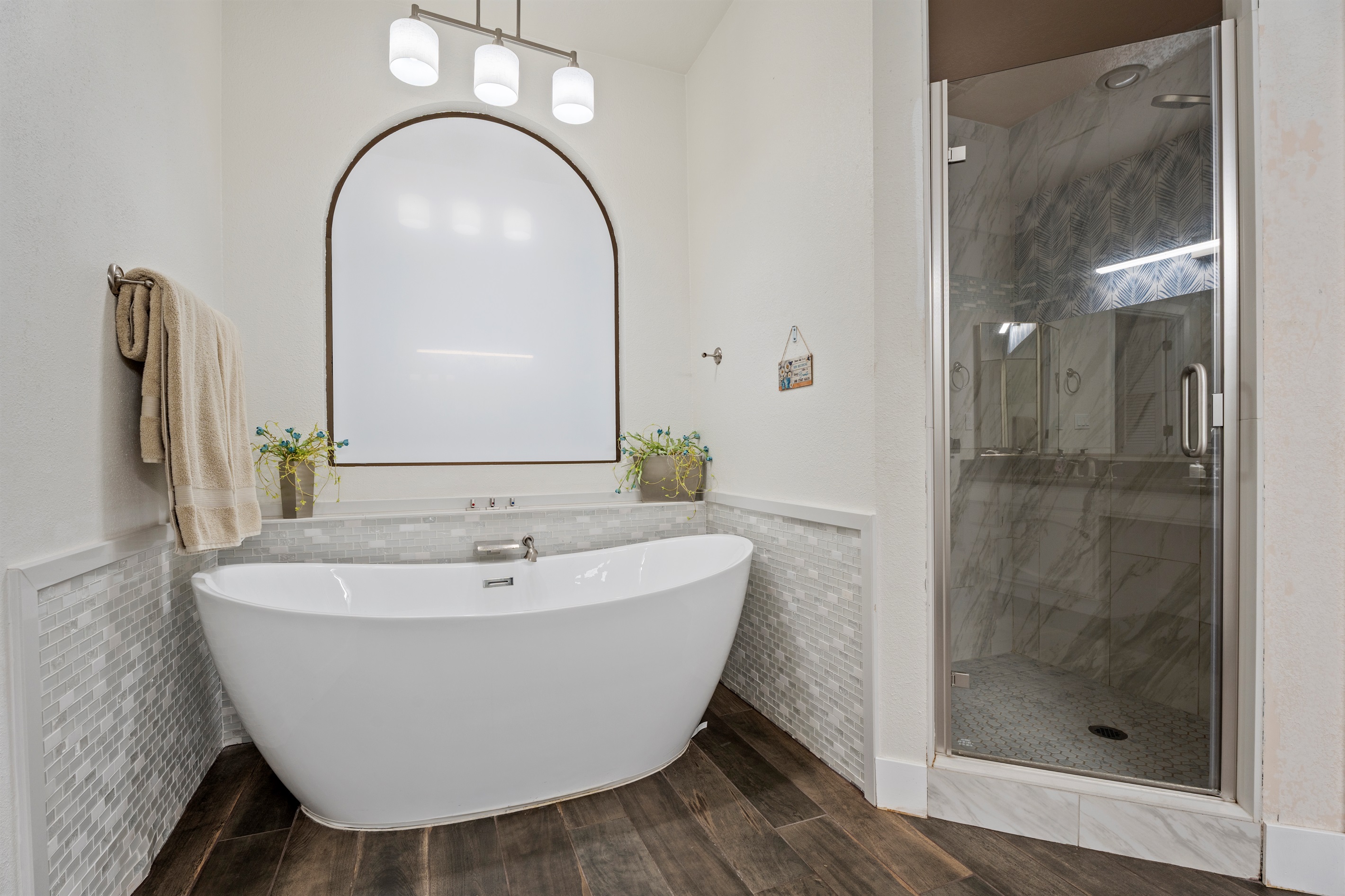 Pamper yourself in this spa-inspired bathroom with a freestanding tub, double sinks, and soothing neutral finishes.