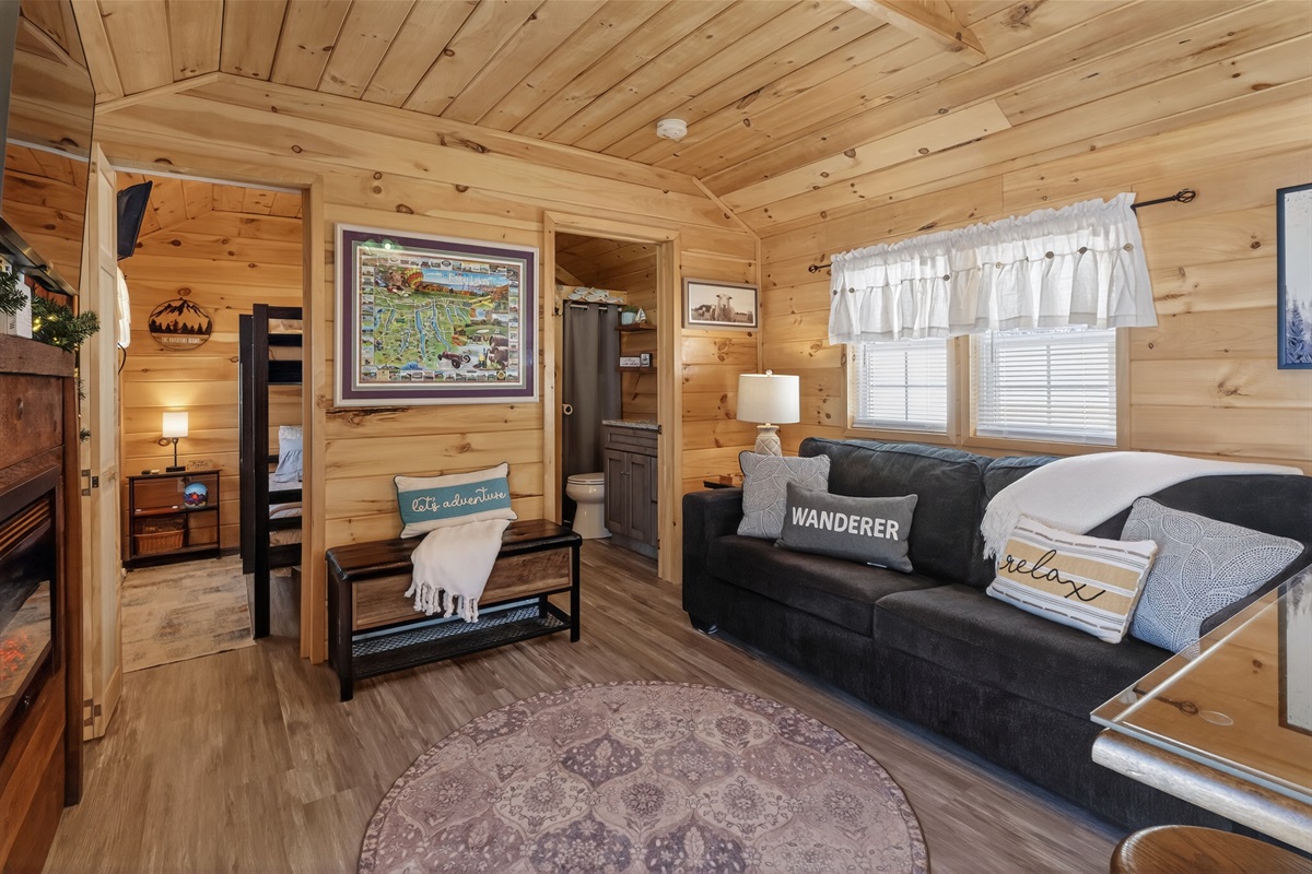 Tiny house living room with bathroom and bunk room entry