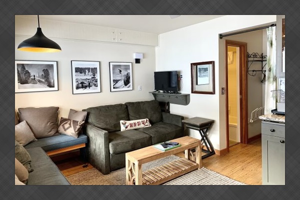Living room area leading to bathroom & small room with bunkbeds.