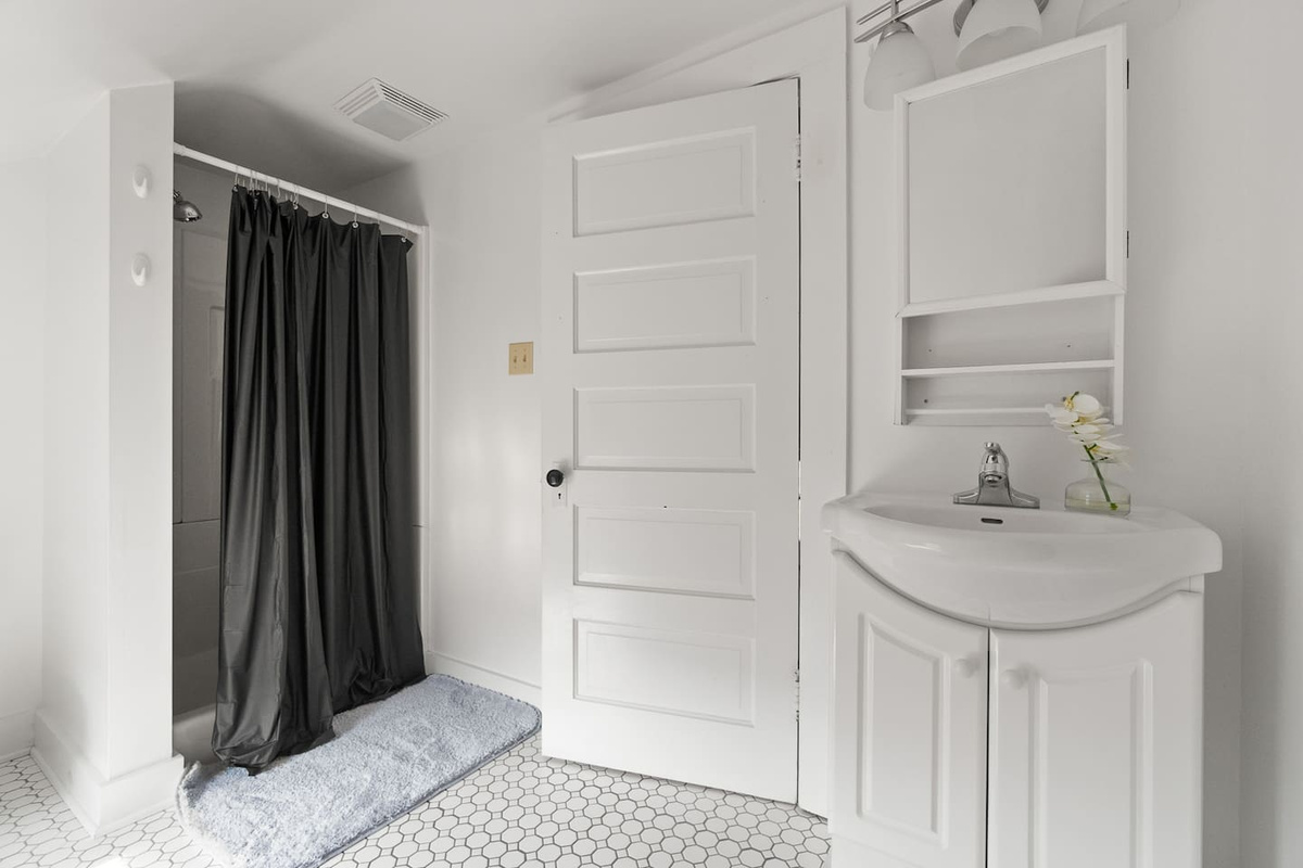 Bright and airy bathroom with all-white interiors, featuring sleek fixtures, clean lines, and a minimalist design that creates a fresh and calming atmosphere.
