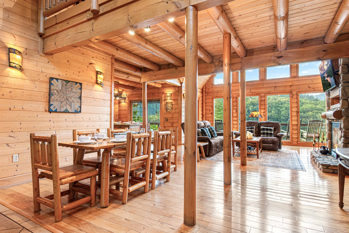 Main Level Dining Room: Gather around the rustic wood table with stunning views of the lush outdoors!