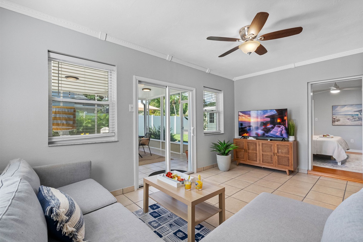 Your favorite streaming apps are just a click away on the large smart TV, surrounded by cozy armchairs and a deep, soft sofa.