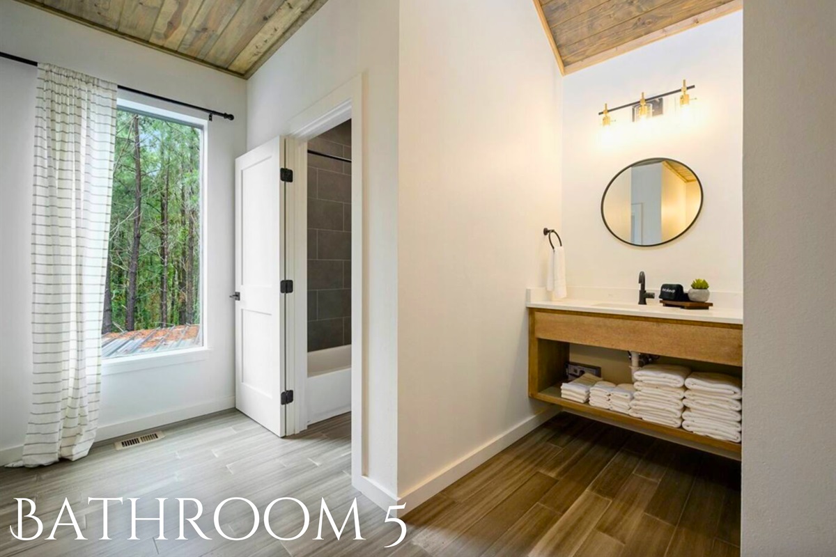 This clean and bright bathroom is perfectly suited for guests, complete with all the necessary amenities.
