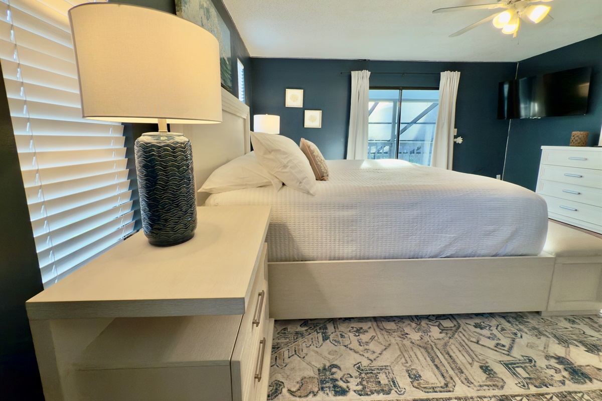The deep navy accent walls create a rich, moody atmosphere that feels both calming and sophisticated.