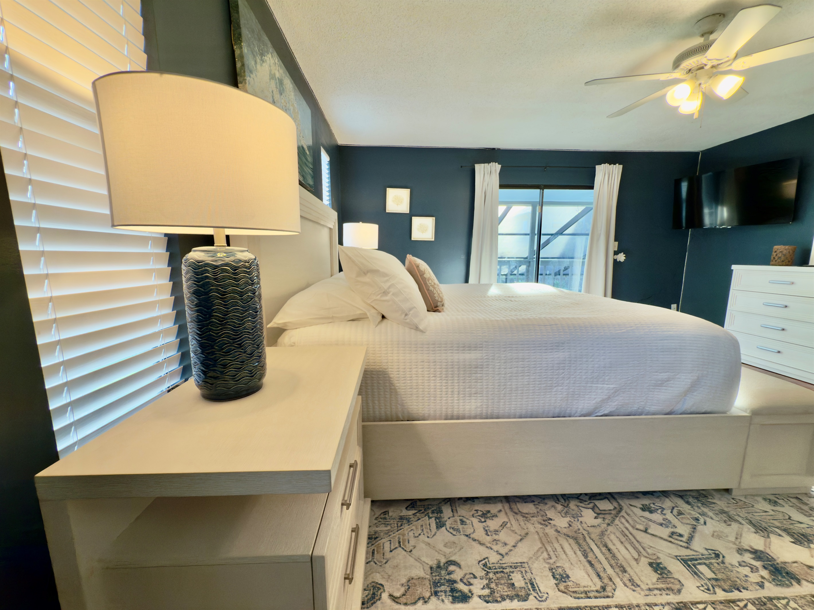 The deep navy accent walls create a rich, moody atmosphere that feels both calming and sophisticated.