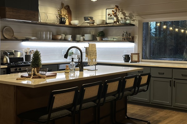 Easy-to-navigate open shelves, a flip out window to the back porch, and plenty of island seating. Our kitchen has every gadget you need to feed your crew!