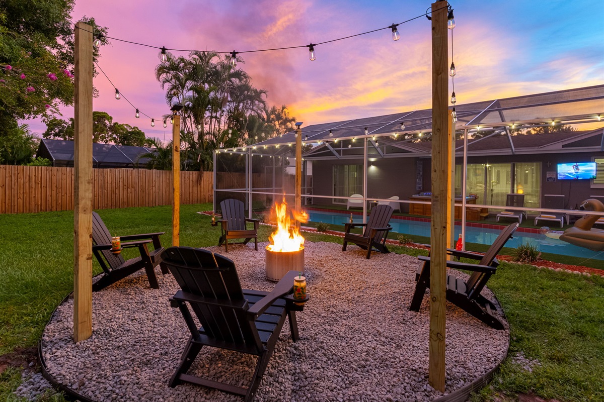 Gather around the glowing fire pit under string lights and a painted sky—perfect for toasting marshmallows and making memories.