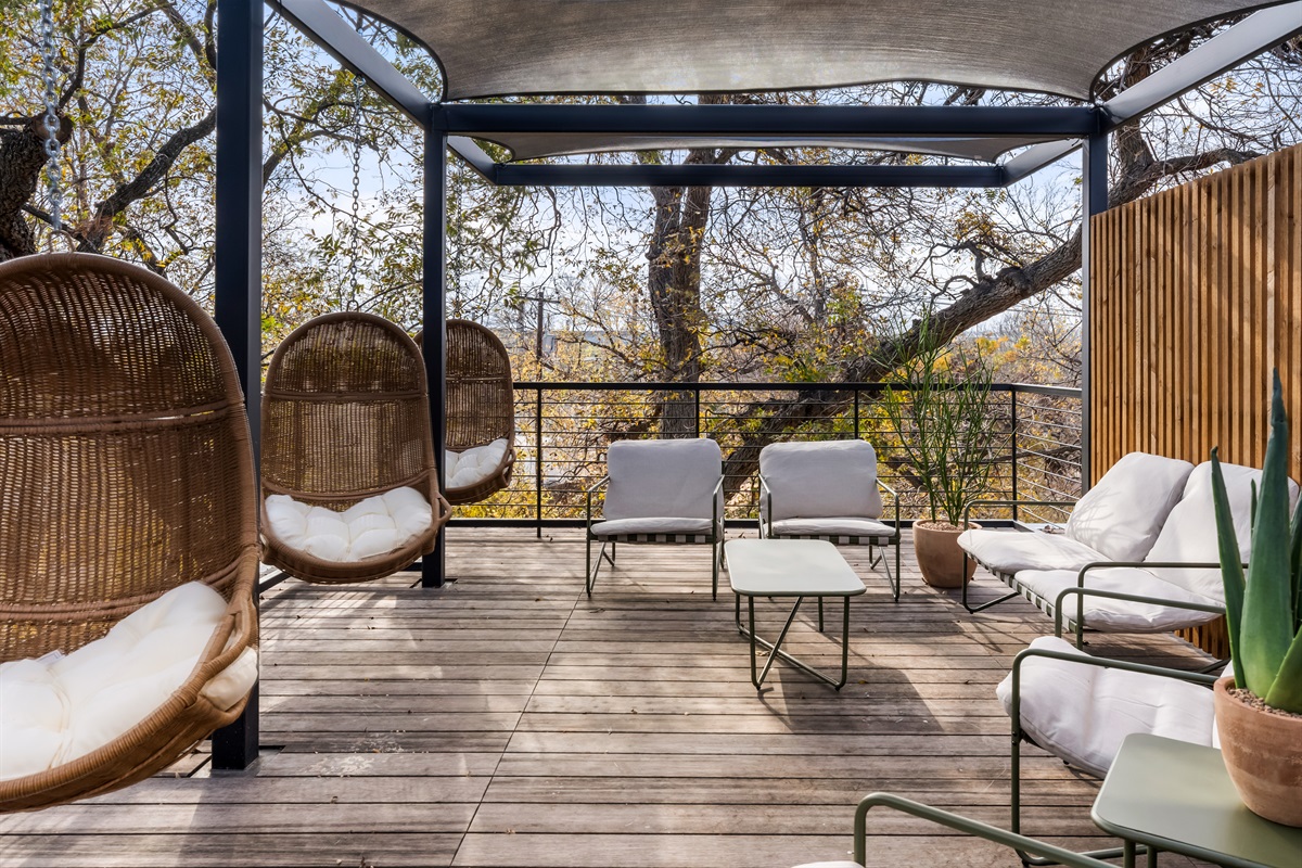 Elevated terrace with lounge seating and treetop views—perfect for morning coffee, sunset drinks, or relaxing in the open air.