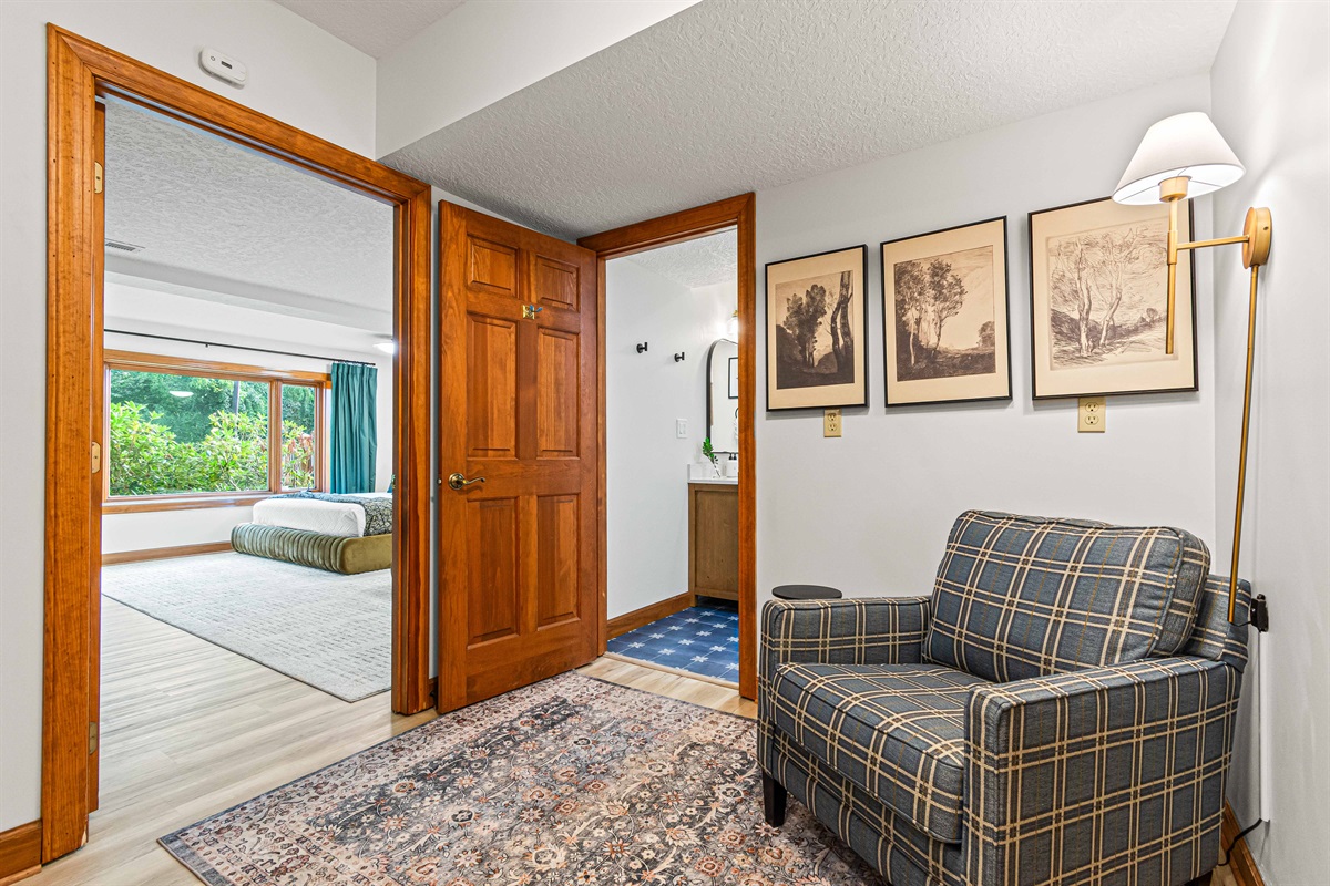 A cozy reading nook connects the lower-level River Arts bedroom and bathroom—perfect for a little quiet time.