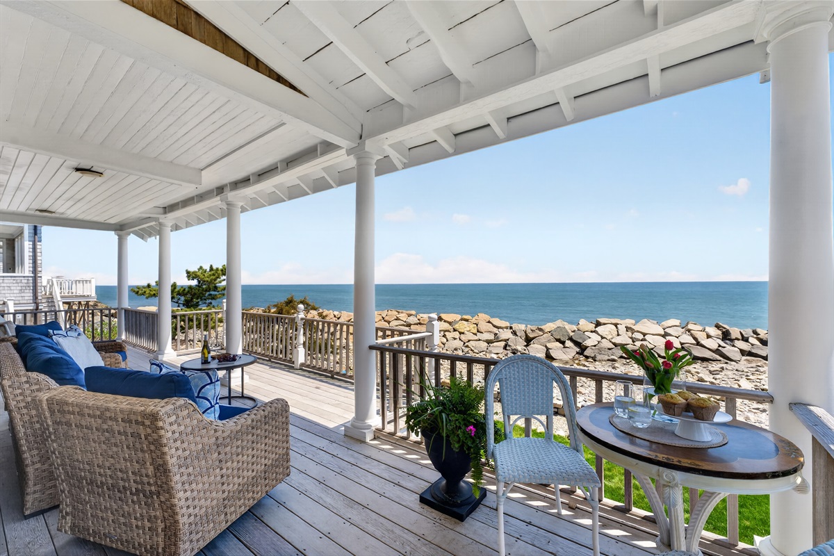 Spacious oceanfront deck with cozy seating, where you can unwind, take in the fresh sea breeze, and enjoy beautiful coastal views just steps from the shore. 🌊