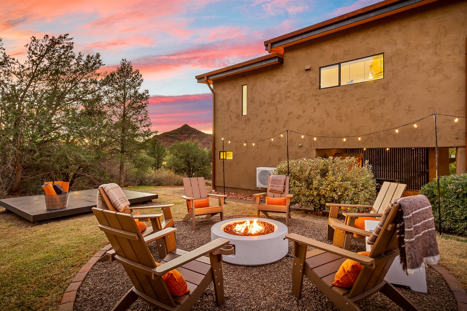 Gather around the fire as the sun sets over Sedona, where quiet desert evenings, string lights, and warm conversation create a true retreat atmosphere.