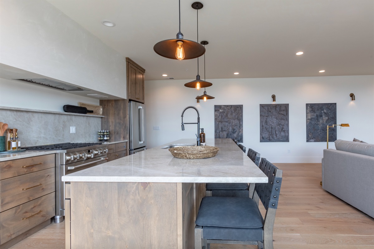 Middle Teton - Chef’s kitchen featuring high-end appliances, quartz countertops, and ample seating.