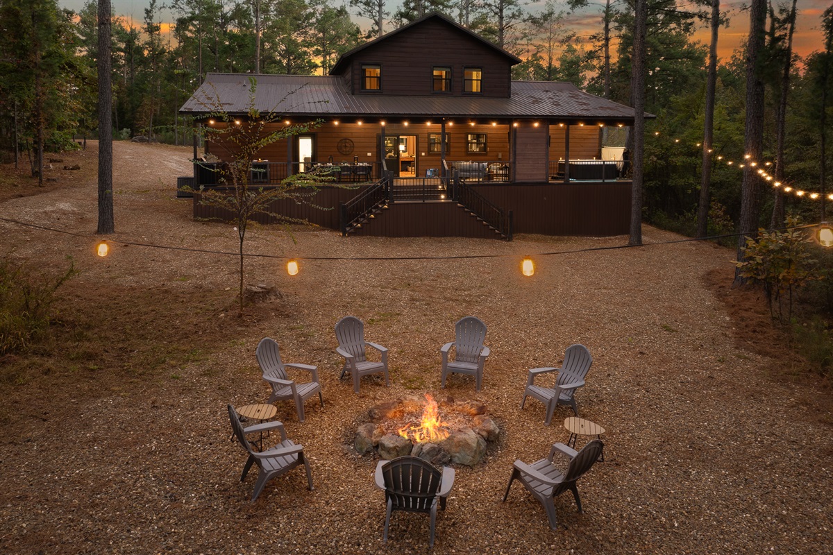 Evenings by the fire feel magical under the trees. This spacious gathering spot is made for slow conversations and s more filled nights.