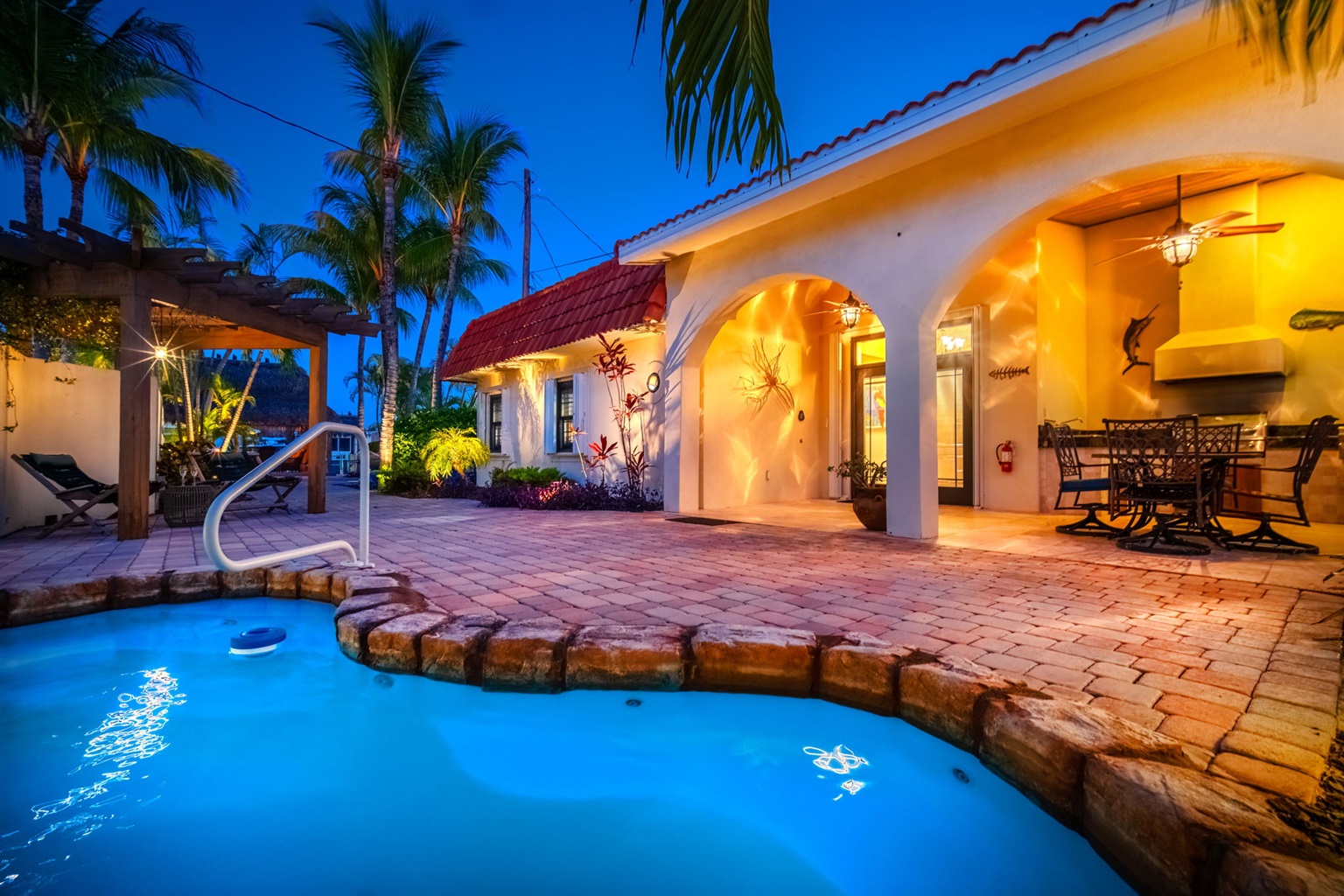 Enjoy the heated pool in your private tropical backyard oasis.