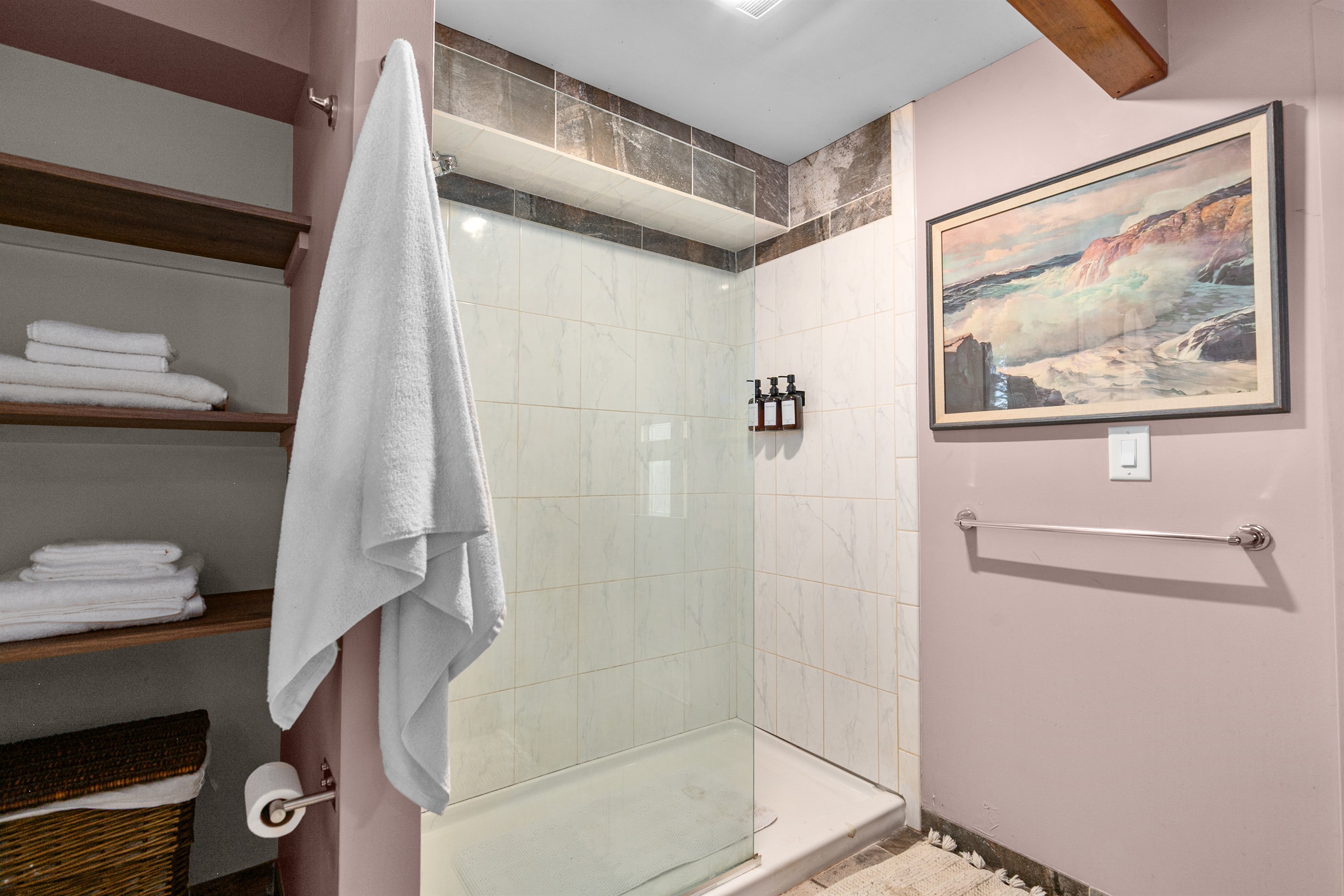 The glass walk-in shower is stocked with shampoo, conditioner, and body wash, so you can refresh with ease during your stay.