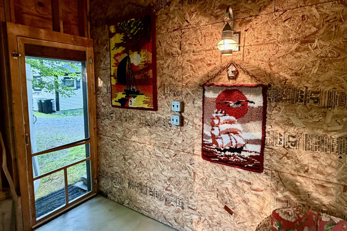 Step inside the Settler's Sidecar lounge, where rustic barn charm meets local heritage. The entryway features warm nautical lighting and unique, custom handmade wall art, welcoming you into your private, unplugged island sanctuary.