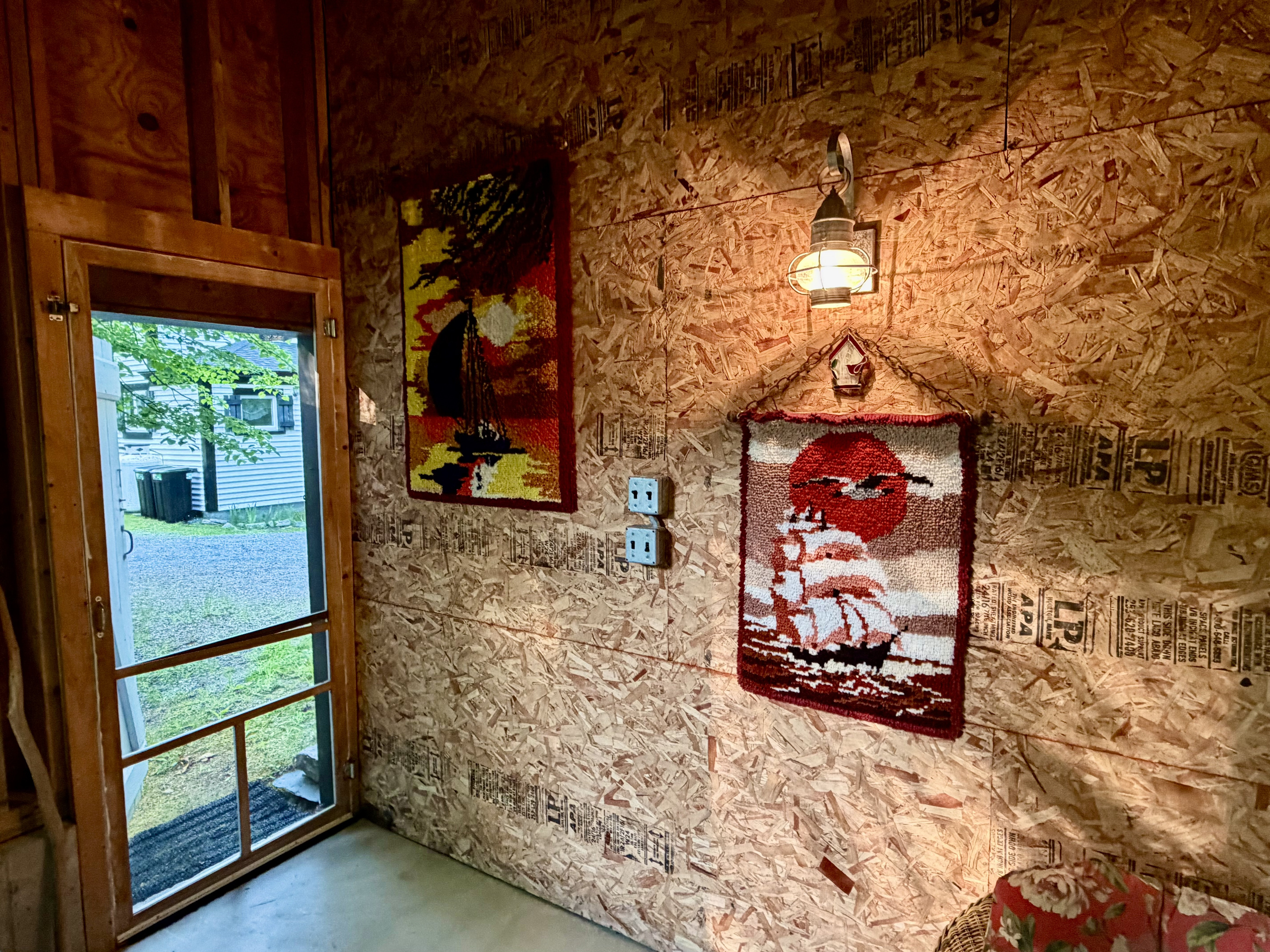 Step inside the Settler's Sidecar lounge, where rustic barn charm meets local heritage. The entryway features warm nautical lighting and unique, custom handmade wall art, welcoming you into your private, unplugged island sanctuary.
