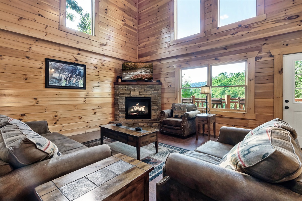 Sink into the soaring, sun drenched living room where vaulted ceilings and warm wood create instant cabin wow.