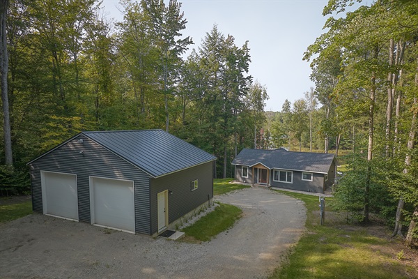 Private drive with parking for cars, trucks, and boat/ATV trailers.