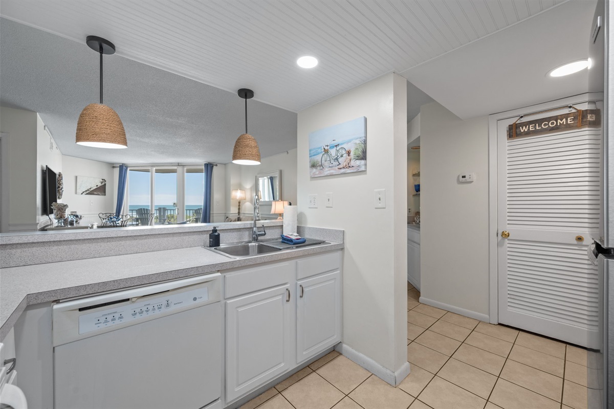 Open kitchen layout with a clear view into the living space and balcony beyond