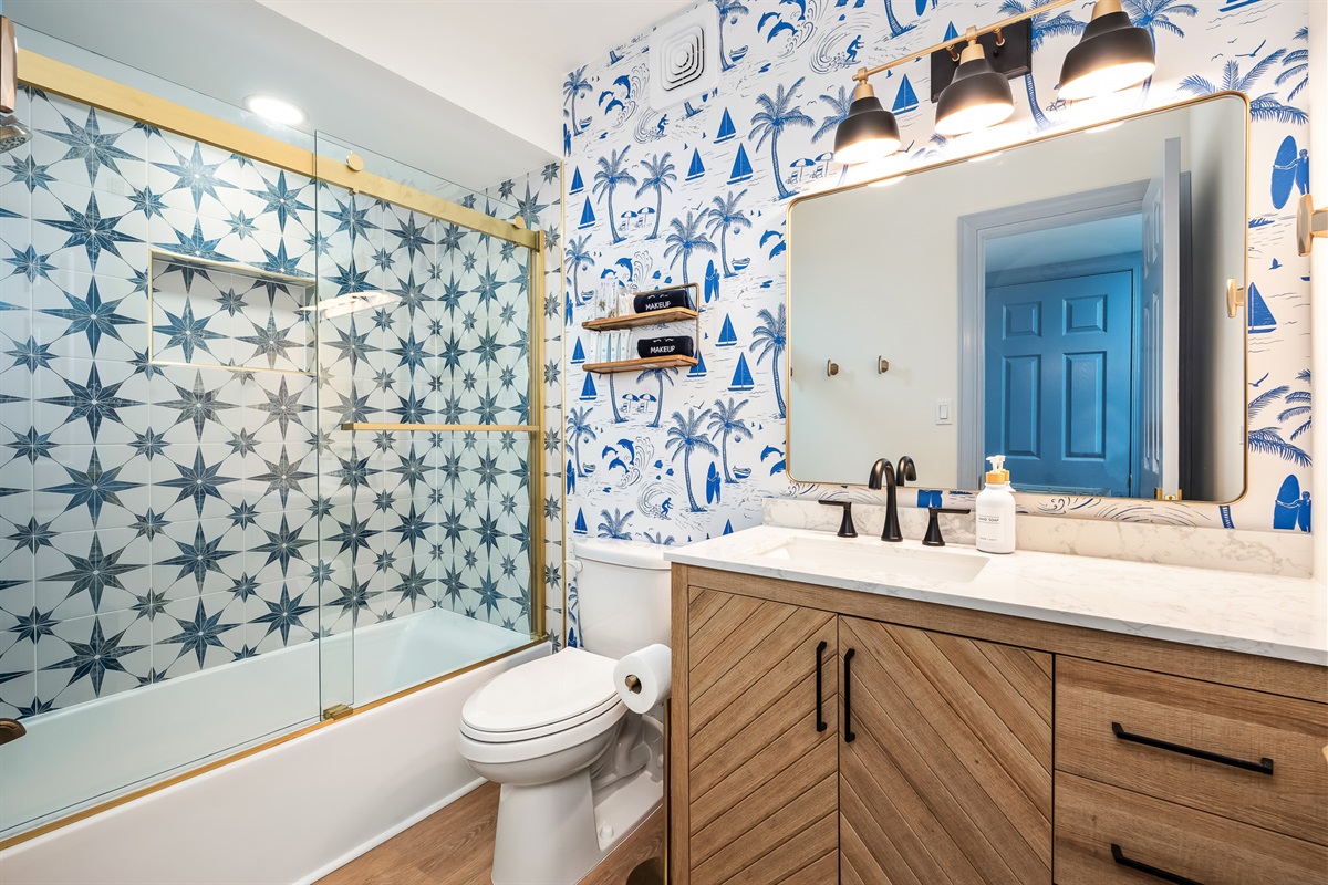 A fun, coastal-inspired bathroom with tub/shower combo.