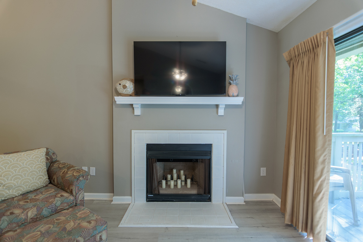 Comfortable living room with large TV and deck access