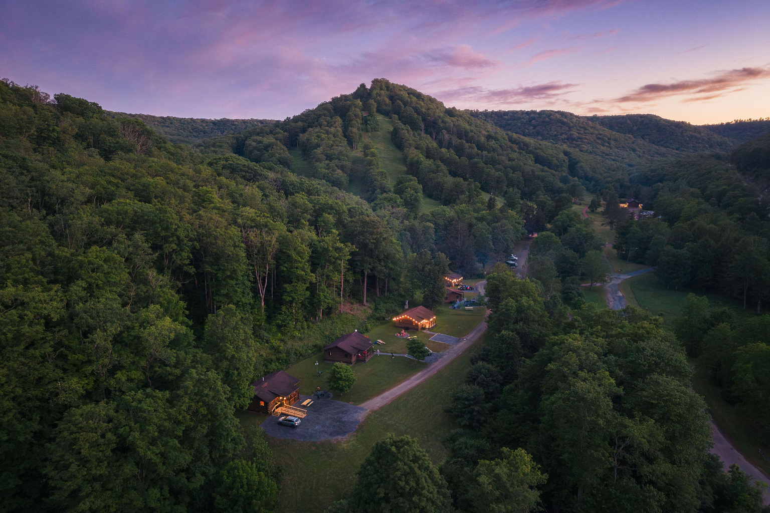 🏕 The cabins from above at dusk — tucked into the heart of Denton Hill State Park.