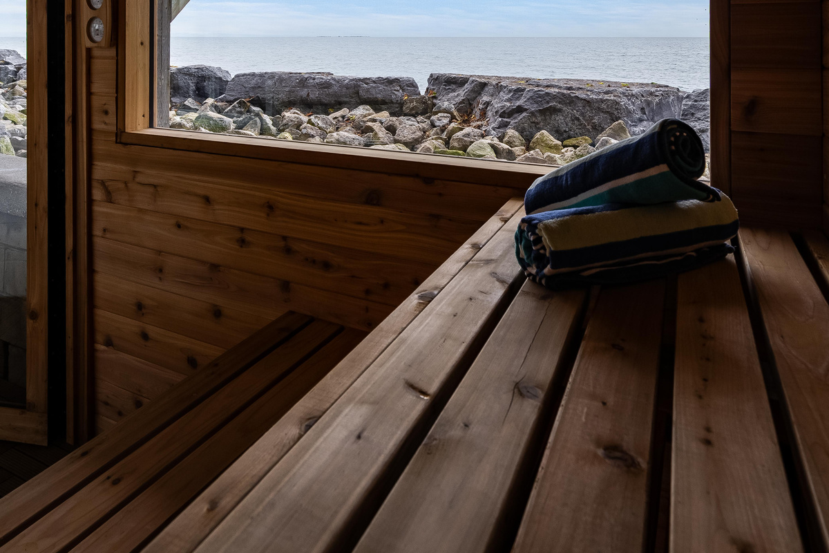Relaxing cedar sauna interior with built-in wooden bench.