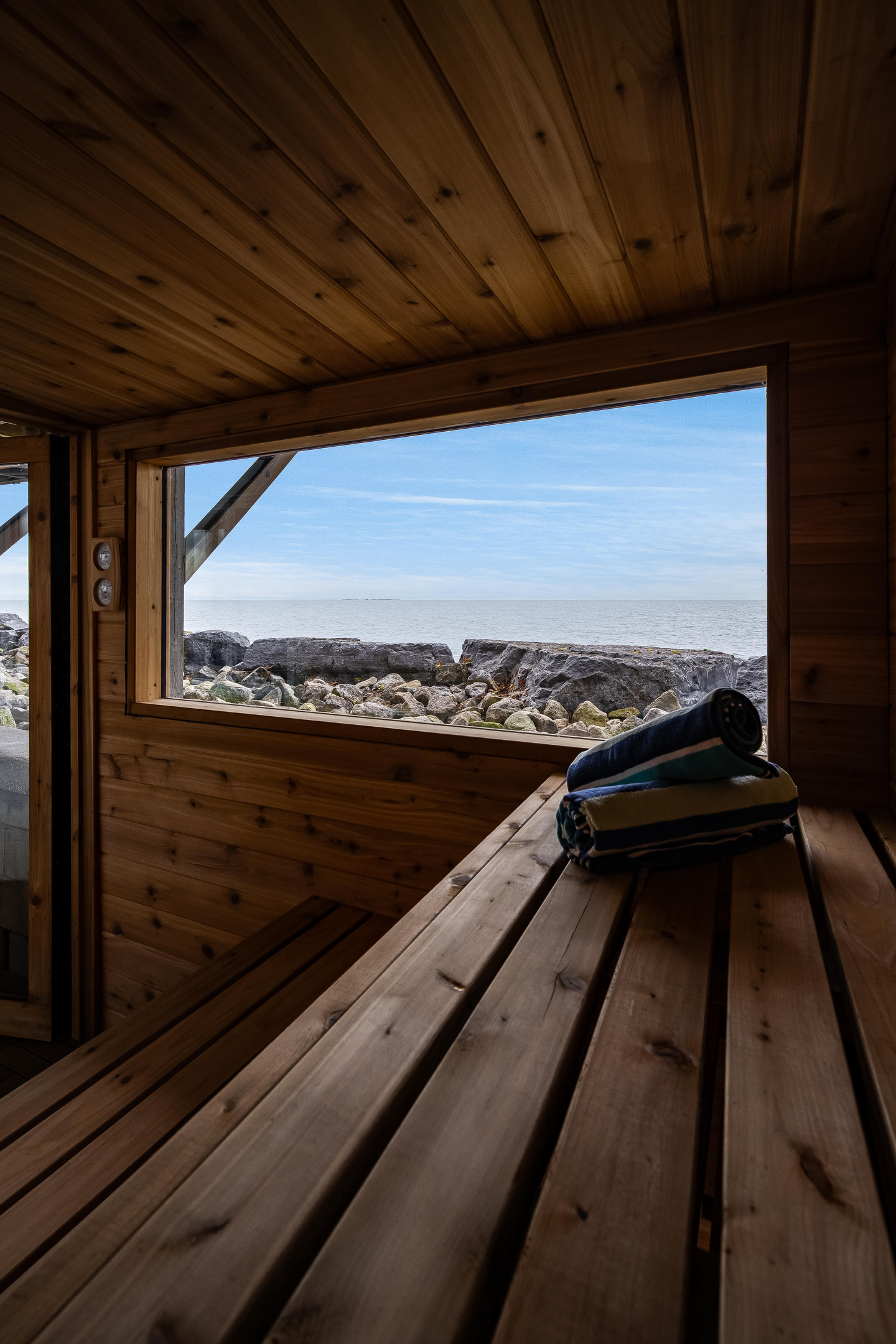 Relaxing cedar sauna interior with built-in wooden bench.
