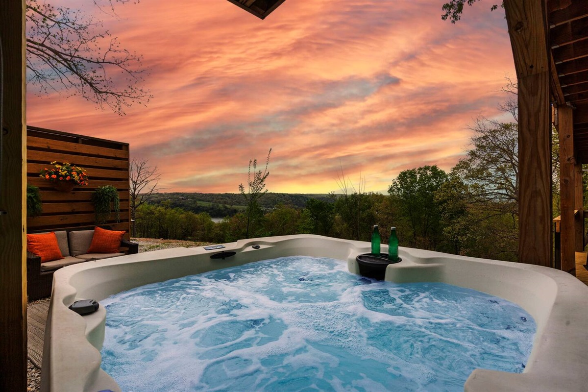 Soak in the hot tub with stunning views of the lake and mountains.