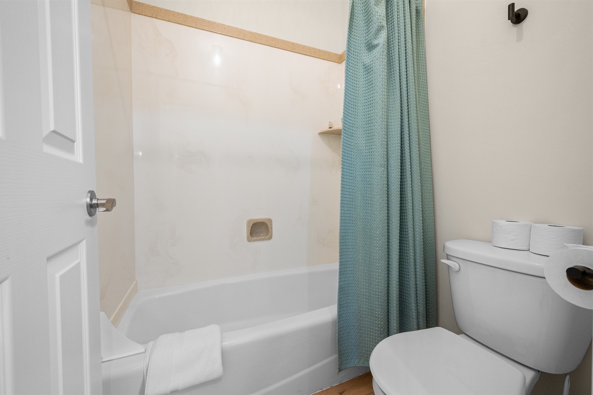 Full bathroom stocked with essentials and fresh towels.