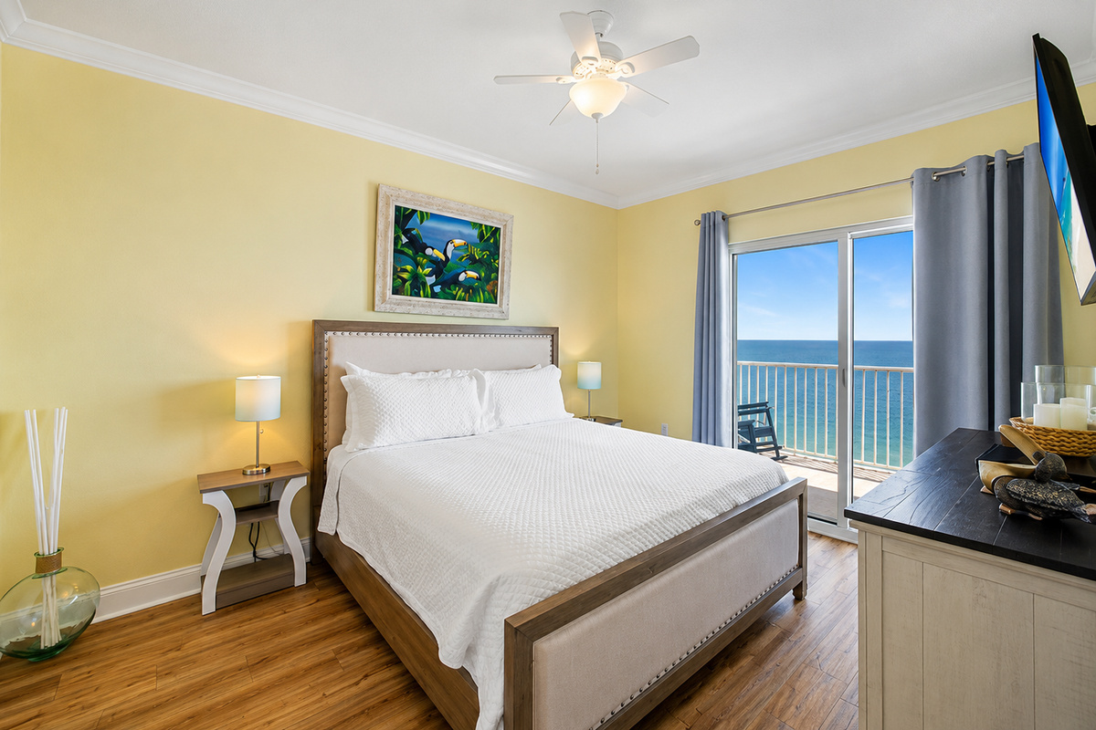 The master bedroom has a comfy king sized bed with access to the balcony. What a view to wake up to each morning!