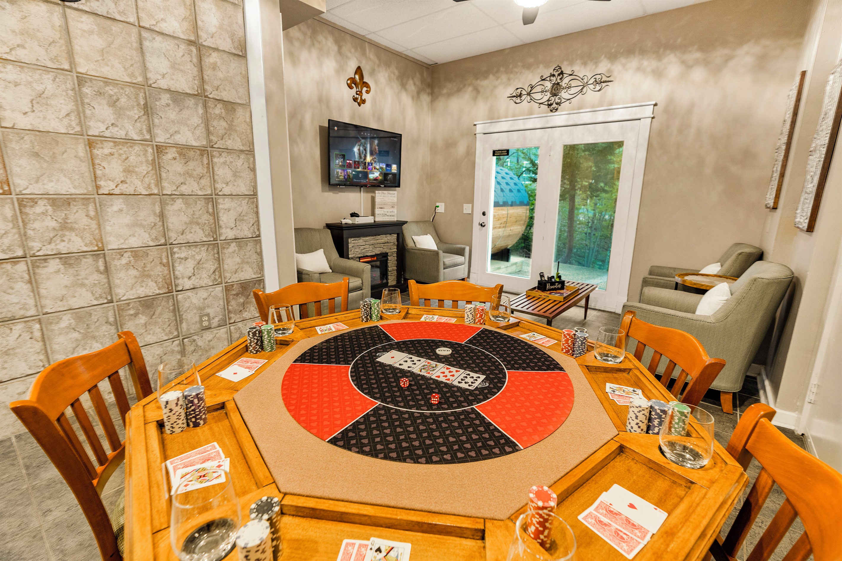 Lounge area with card table and TV with Xbox Series S
