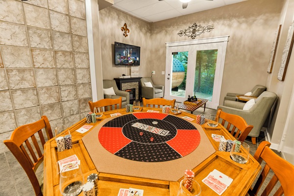 Lounge area with card table and TV with Xbox Series S
