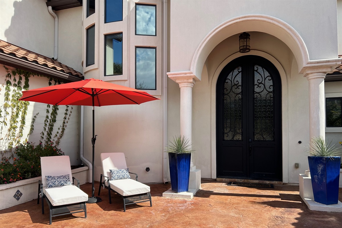 "Welcome to your serene getaway! This beautiful courtyard greets you with lush landscaping, a tranquil fountain, and inviting seating areas—perfect for unwinding and soaking in the peaceful am