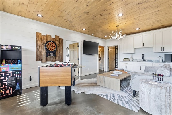 The open layout flows into a cozy living area with 65" TV with sound system, huge coffee table for games, extra seating, and mountain views — perfect for family and friends!