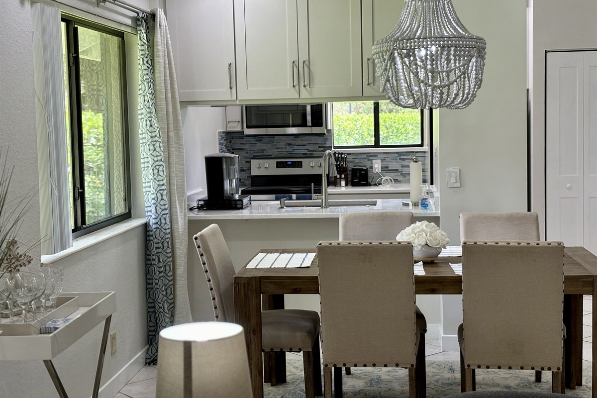 The dining area is right off the kitchen with seating for five, with a convenient bar area located by the window.