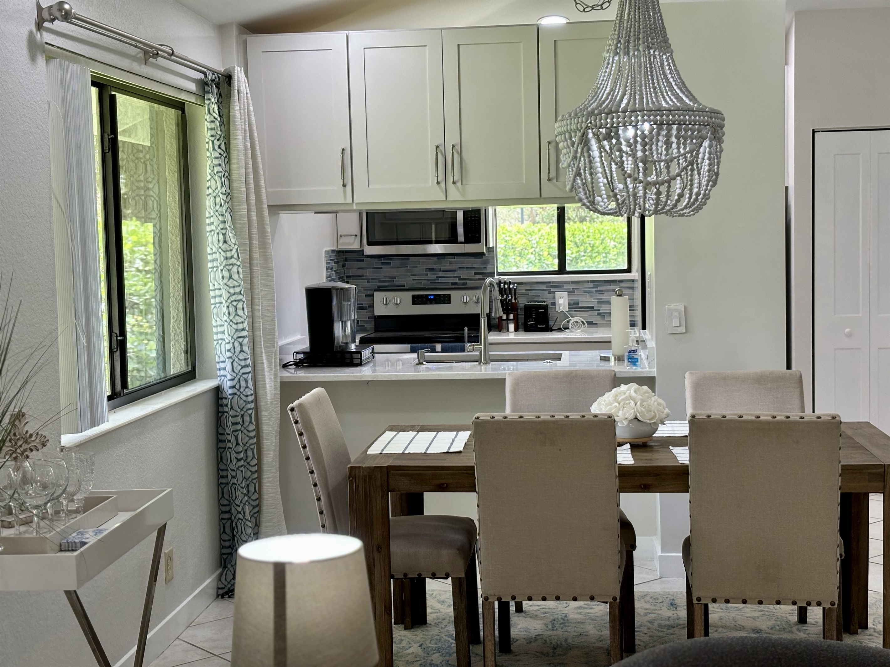 The dining area is right off the kitchen with seating for five, with a convenient bar area located by the window.