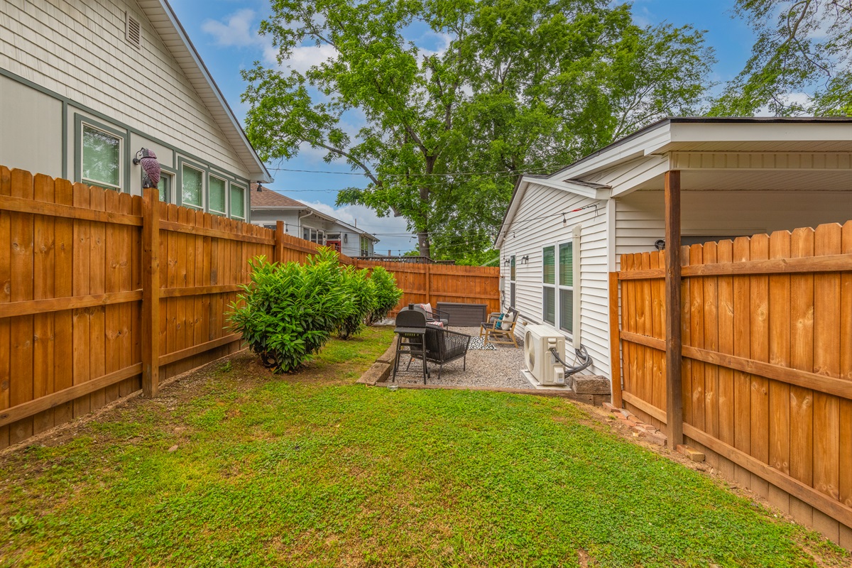 Outdoor lounge space with privacy fence.