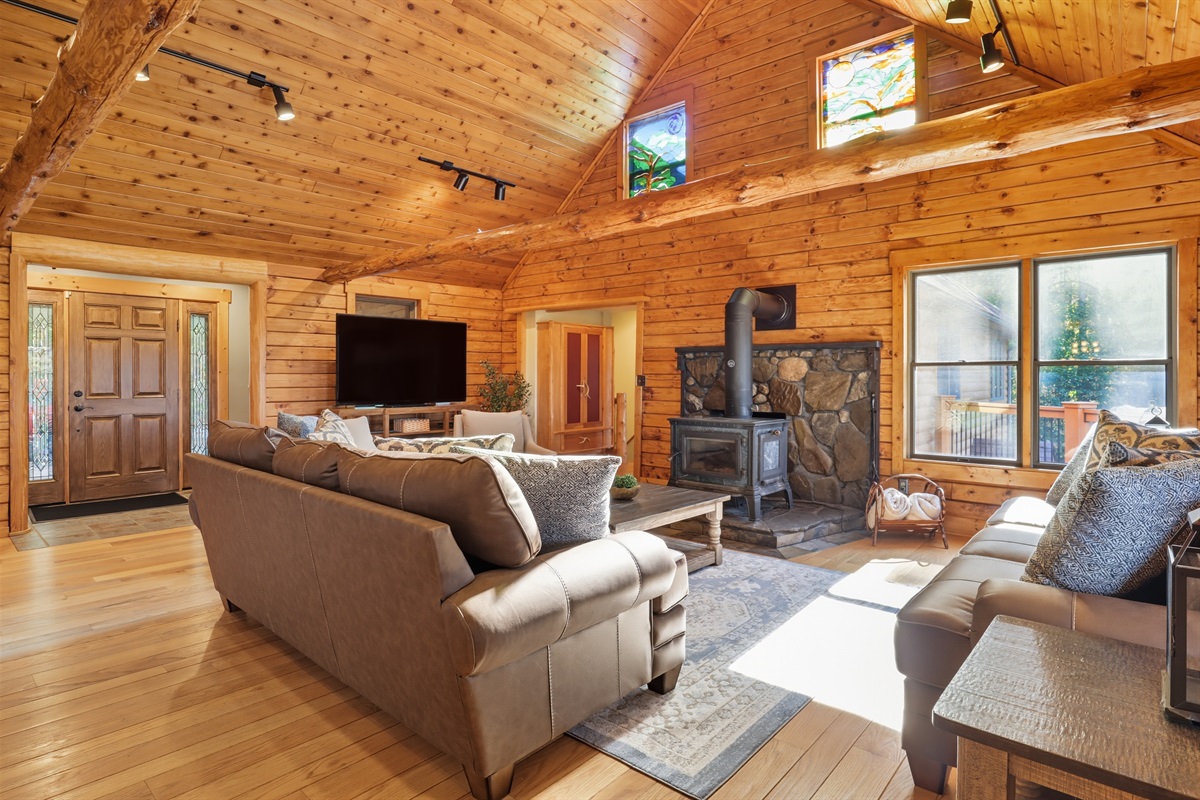 Cozy living space with wood-burning stove and abundant natural light.