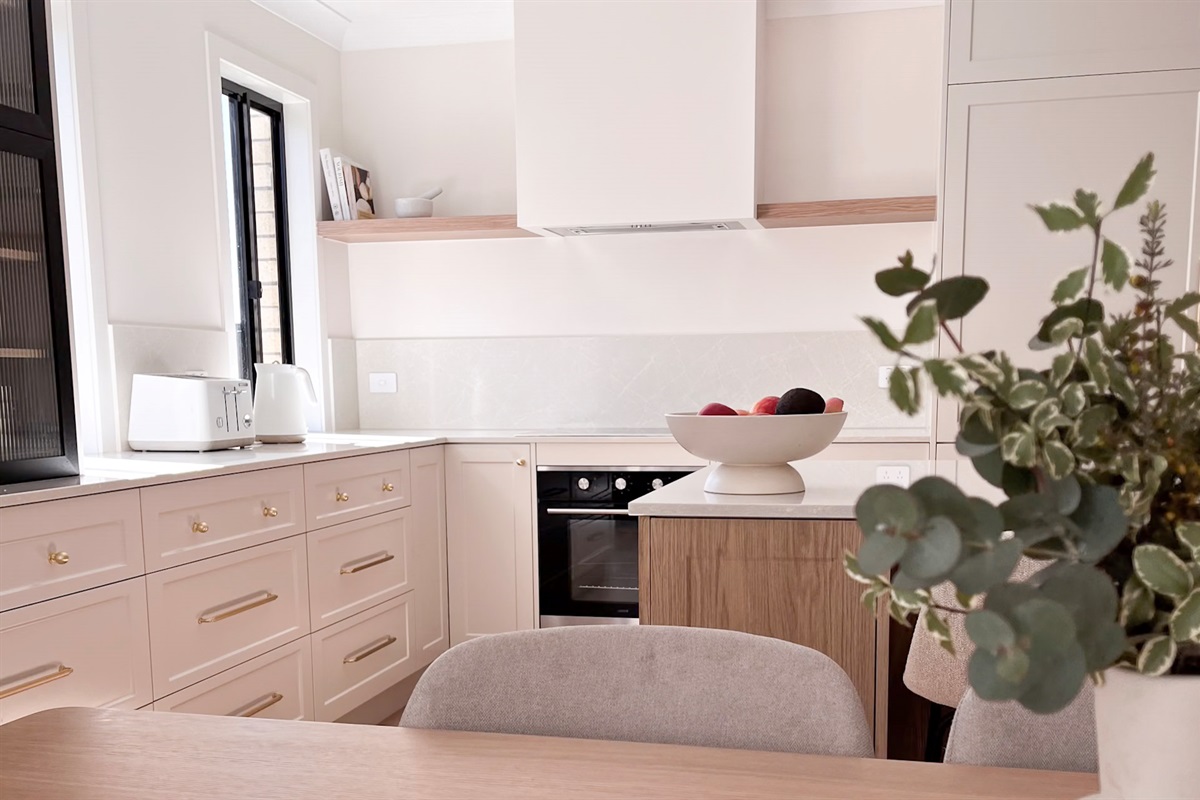 Summers Green View Retreat in Logan Reserve includes a full kitchen with island bench space, cabinetry and open-plan flow.