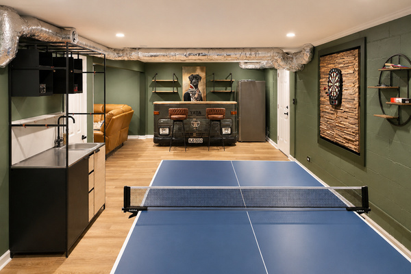 Game room view with ping pong, wet bar, lounge seating and an easy setup for family game nights.