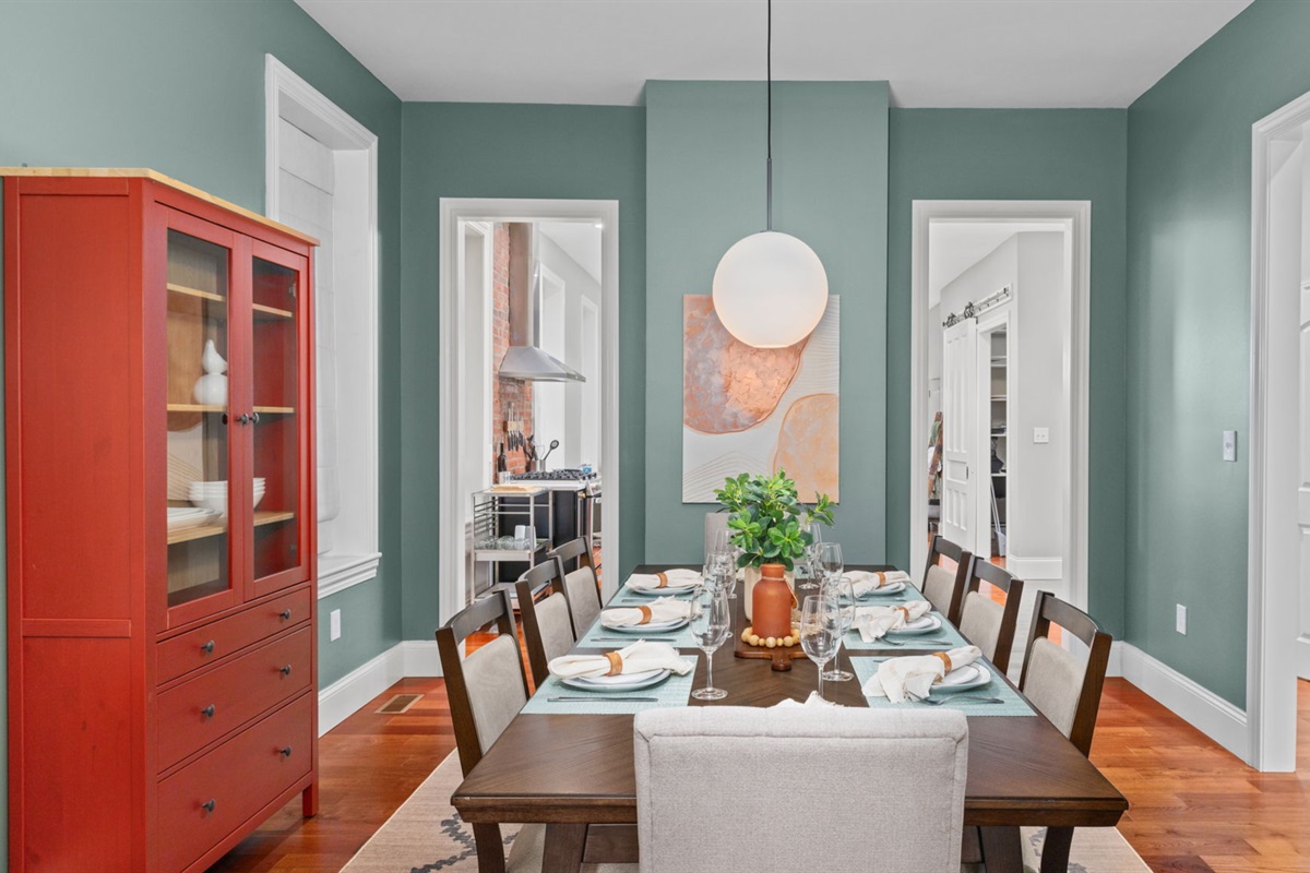 Comfortable seating for 8 in the dining room.  A convertible high chair and booster seat are also available in the corner.