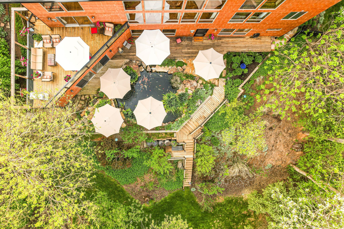 Private multi-level retreat in the heart of Abingdon. Both the sunny upper deck and shaded lower deck feature dedicated lounge seating and outdoor dining areas alongside the 7,000-gallon koi pond.