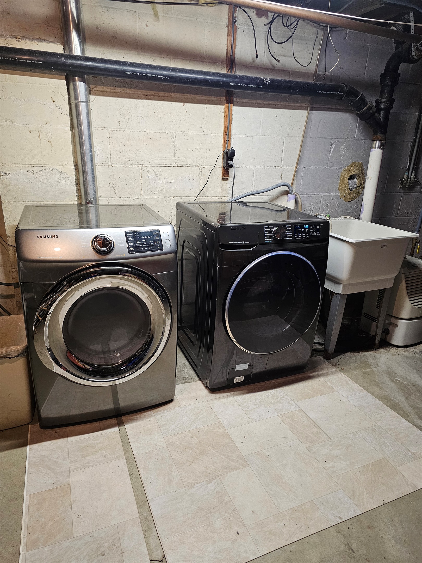 Laundry room in basement. Includes iron, drying racks and other related items.