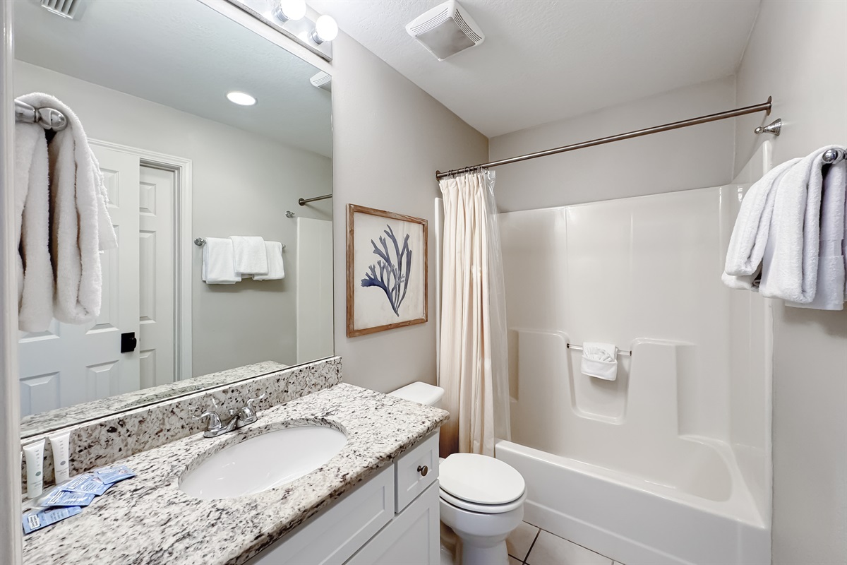 Freshly updated bathroom featuring a shower/tub combination, ample vanity space, and modern fixtures.