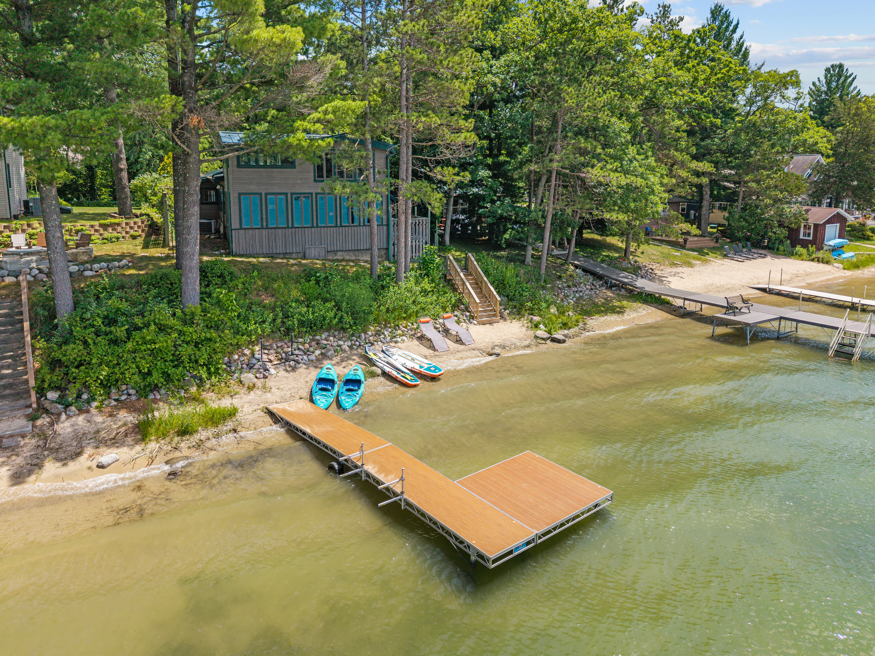 Welcome to your home away from home—a private lakeside escape with a sandy beach, complimentary water toys, and breathtaking views.