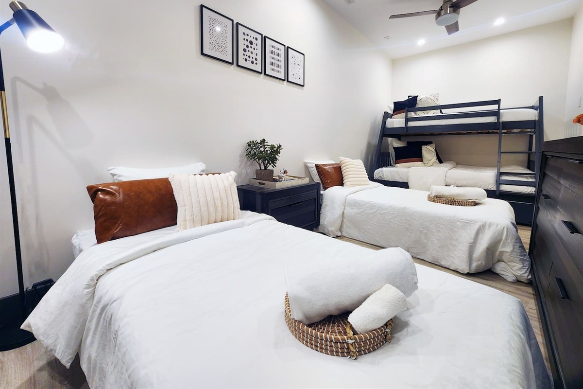 Bedroom with twin over full bunk and trundle with two sleeper chairs converted into two twin beds