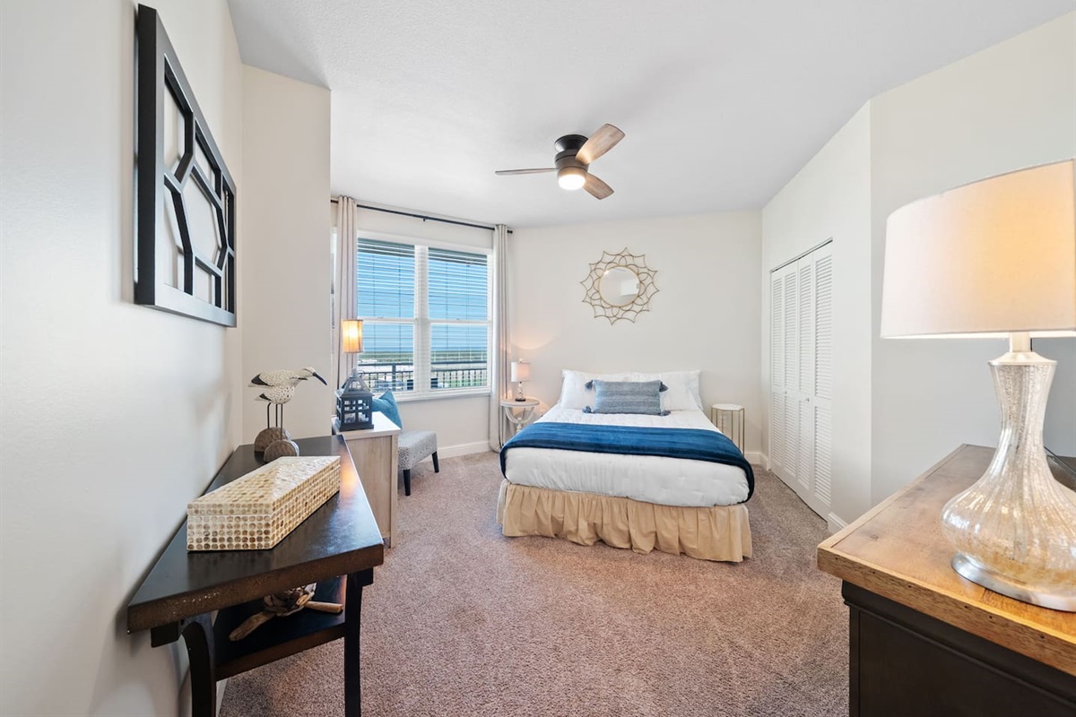 Spacious queen bedroom with city views from the window. Enjoy overlooking Front Beach Rd., TopGolf and the PCB Wheel in the distance.