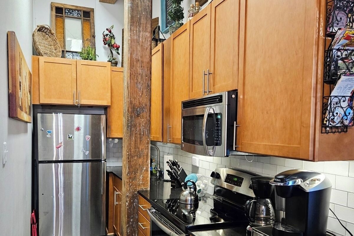 Galley kitchen, fully stocked.